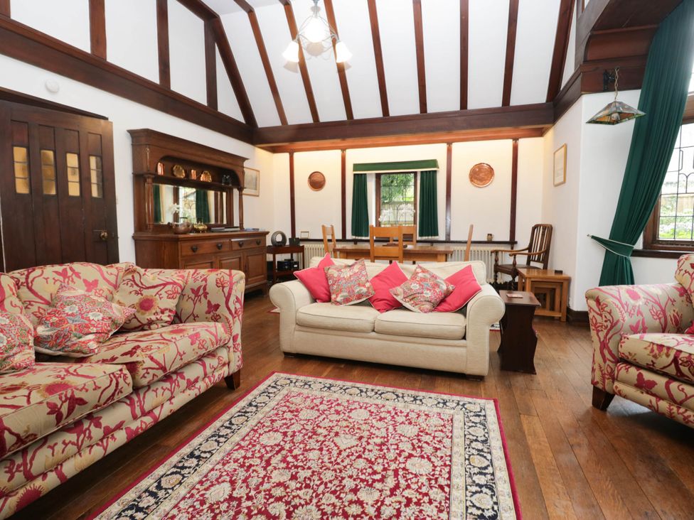 A living room with sofas and a dining table at White Gables in Grasmere