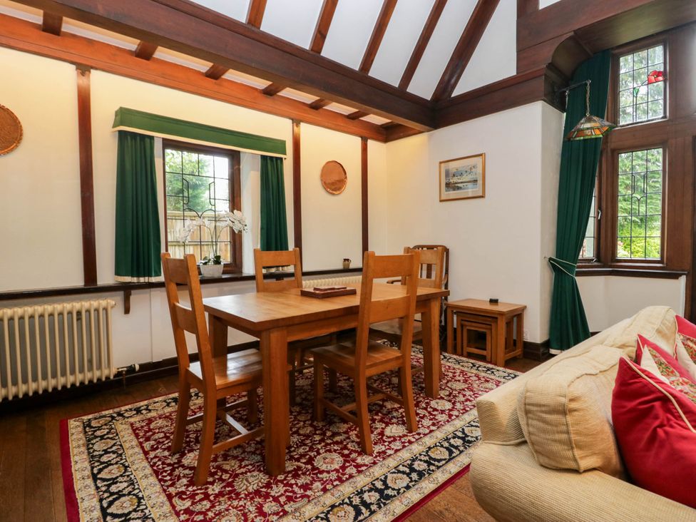 A dining room with a table and chairs at White Gables in Grasmere