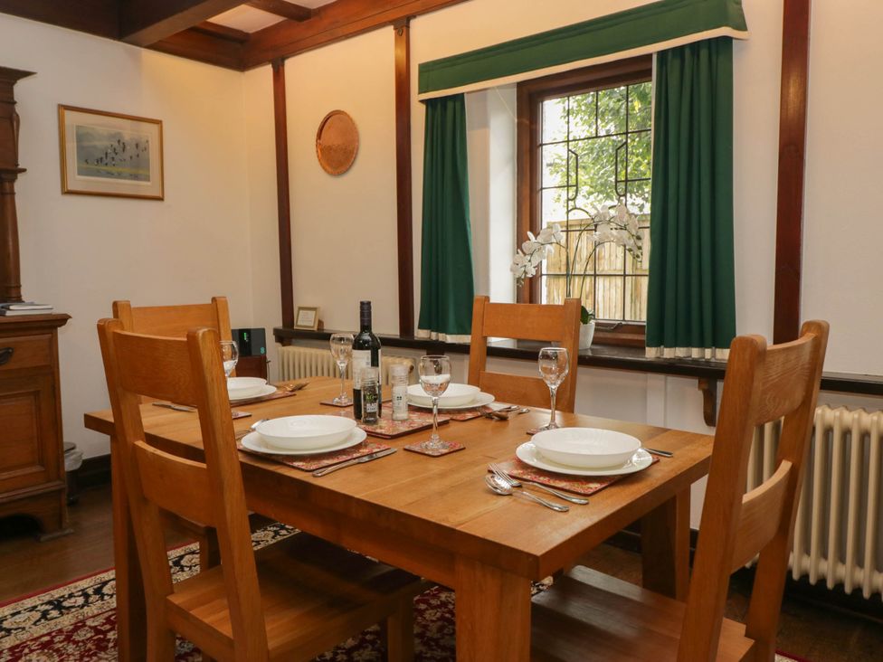 A dining room with a wooden table set at White Gables in Grasmere