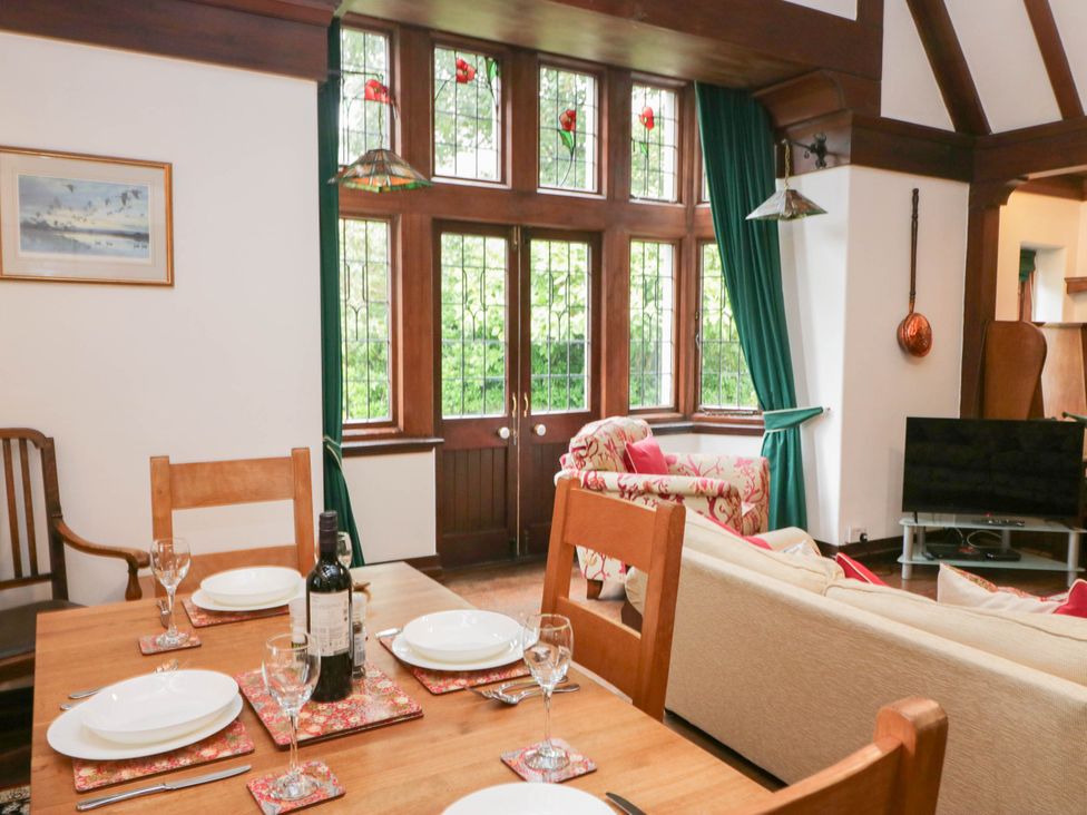 A dining room with a table set for dinner at White Gables in Grasmere