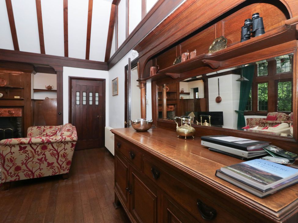 A living room with a sofa and cabinet at White Gables in Grasmere