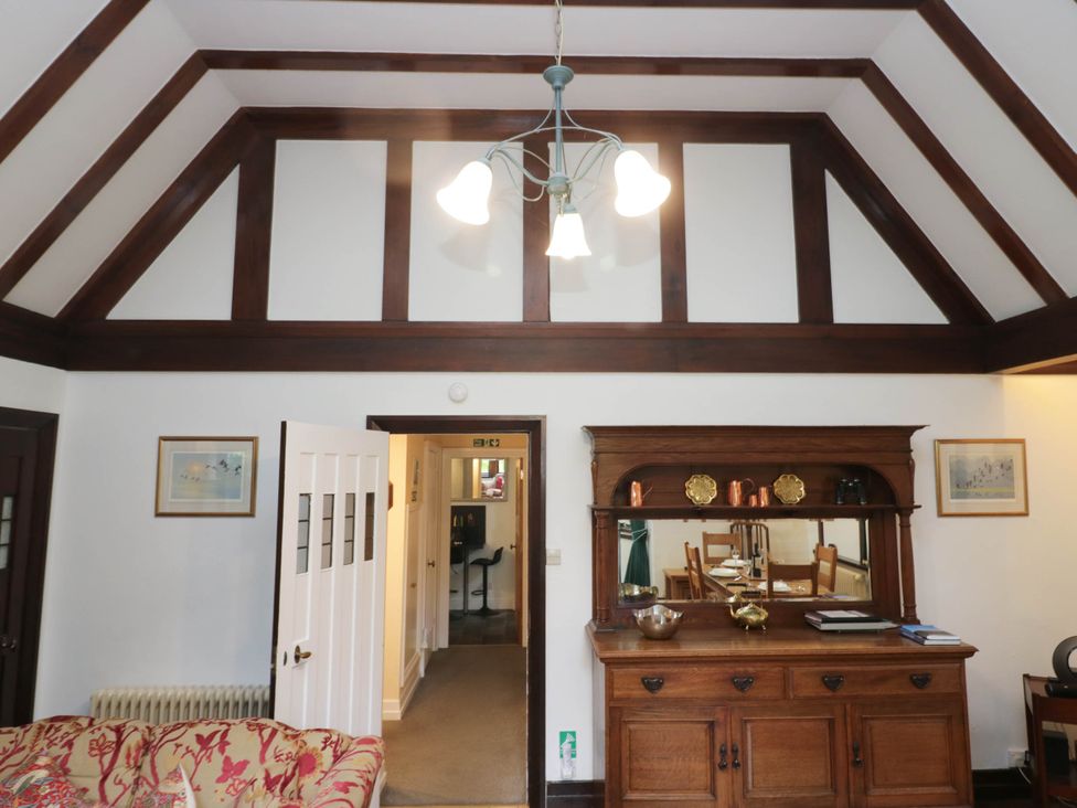 A living room with a sideboard and light fixture at White Gables in Grasmere