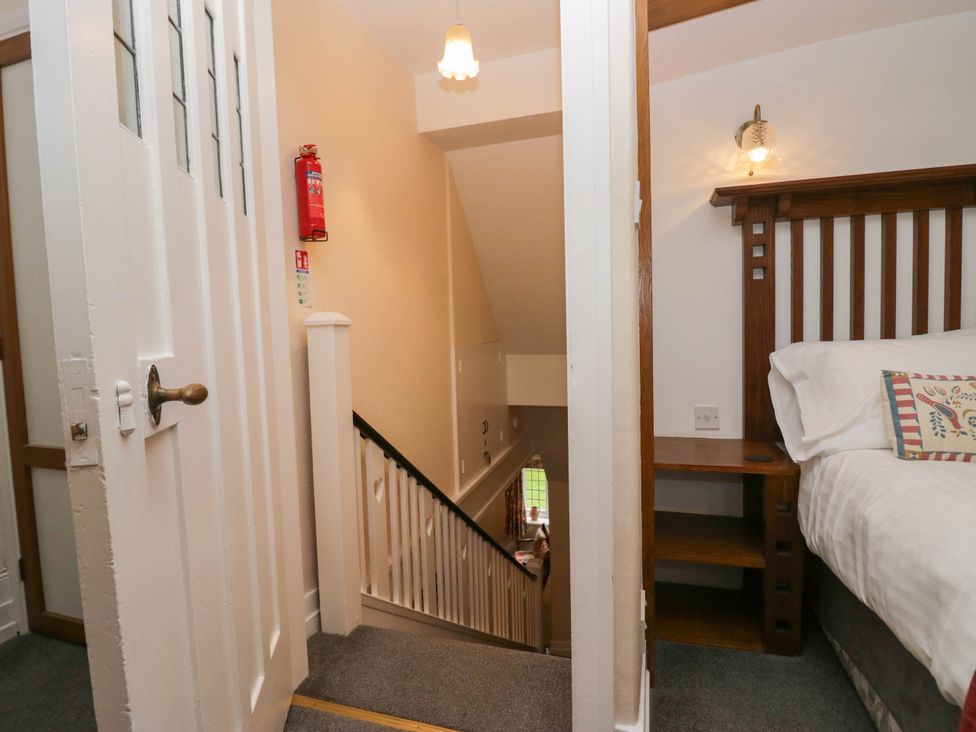 A staircase with a door and bedroom furniture at White Gables in Grasmere