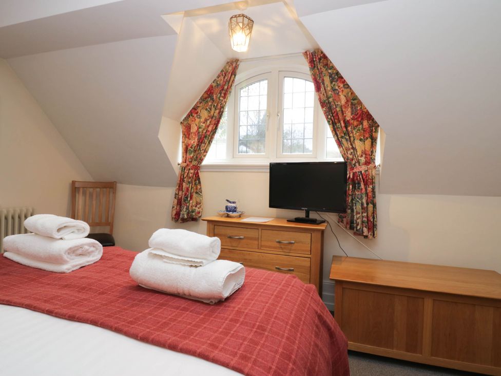 A bedroom with a bed and television at White Gables in Grasmere