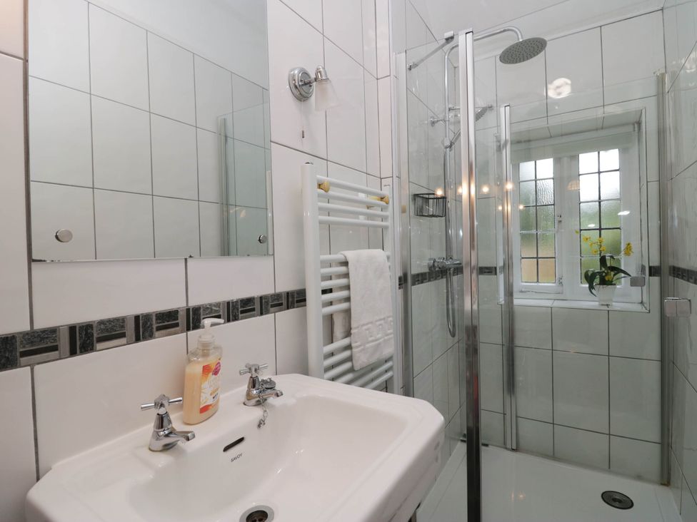 A bathroom with a shower and sink at White Gables in Grasmere