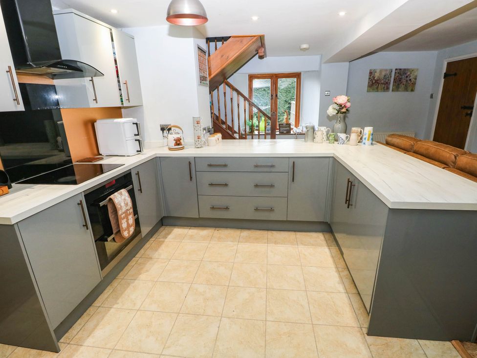 A kitchen with cabinets, countertop, sink and appliances at Greig House Farm Abergavenny