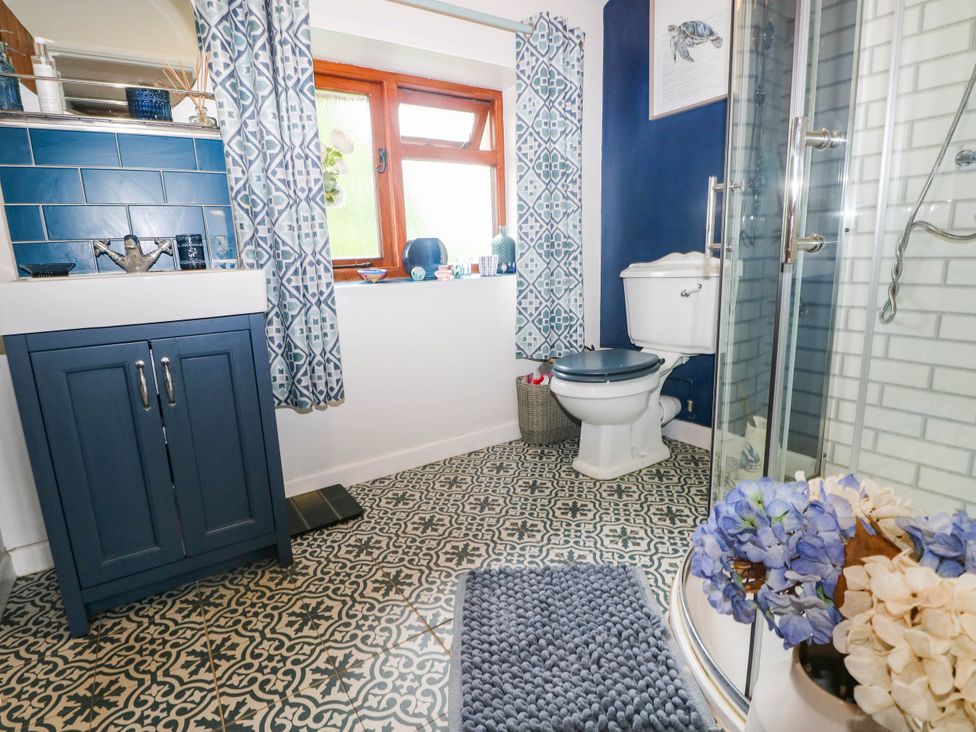 A bathroom with a sink, toilet, and shower at Greig House Farm Abergavenny