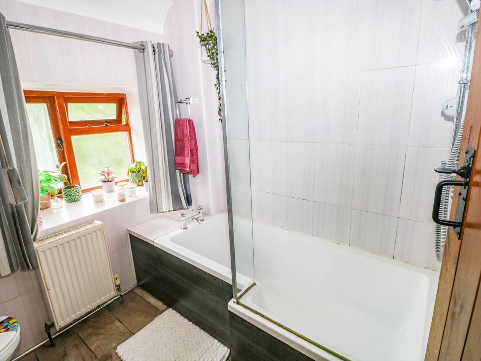 A bathroom with a bathtub and shower at Greig House Farm Abergavenny