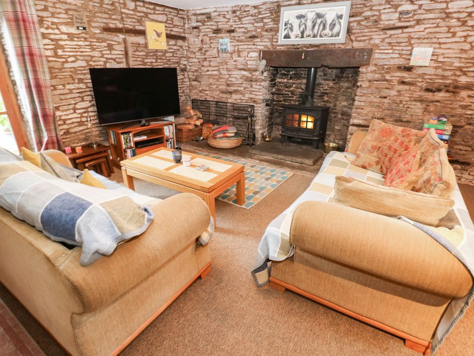 A living room with two sofas and a television at Greig House Cottage Abergavenny