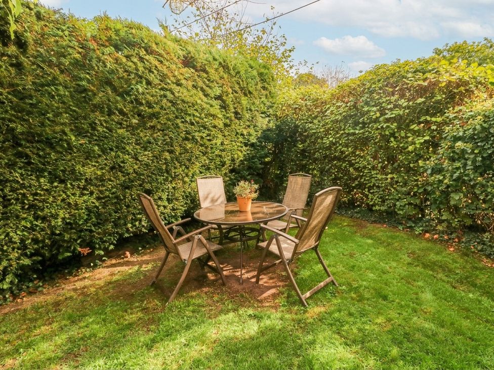 A table and chairs in a garden at Greig House Cottage Abergavenny