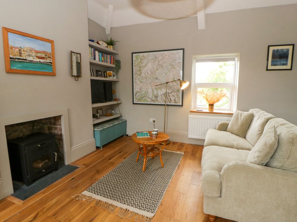A living room with a sofa and a coffee table at Flat 5 Hereford