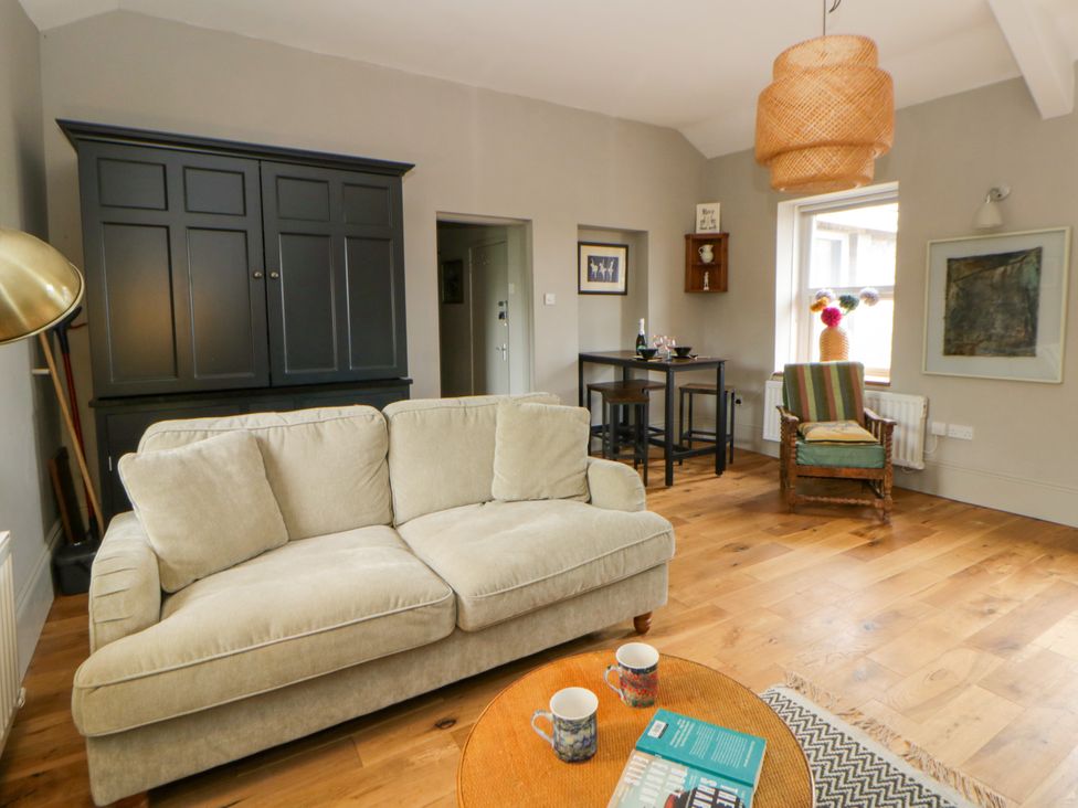 A living room with a sofa and coffee table at Flat 5 in Hereford