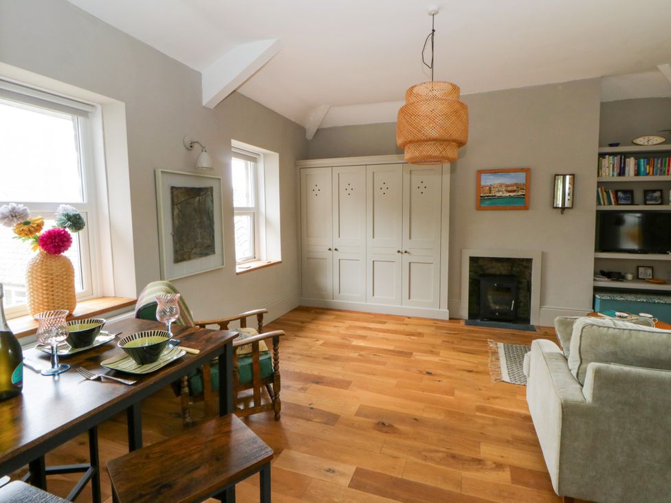 A living room with a dining table and sofa at Flat 5 in Hereford