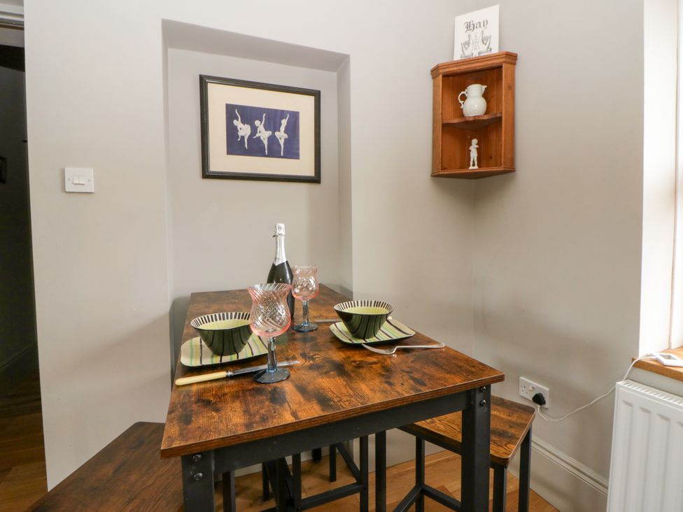 A dining table with glassware and plates at Flat 5 in Hereford