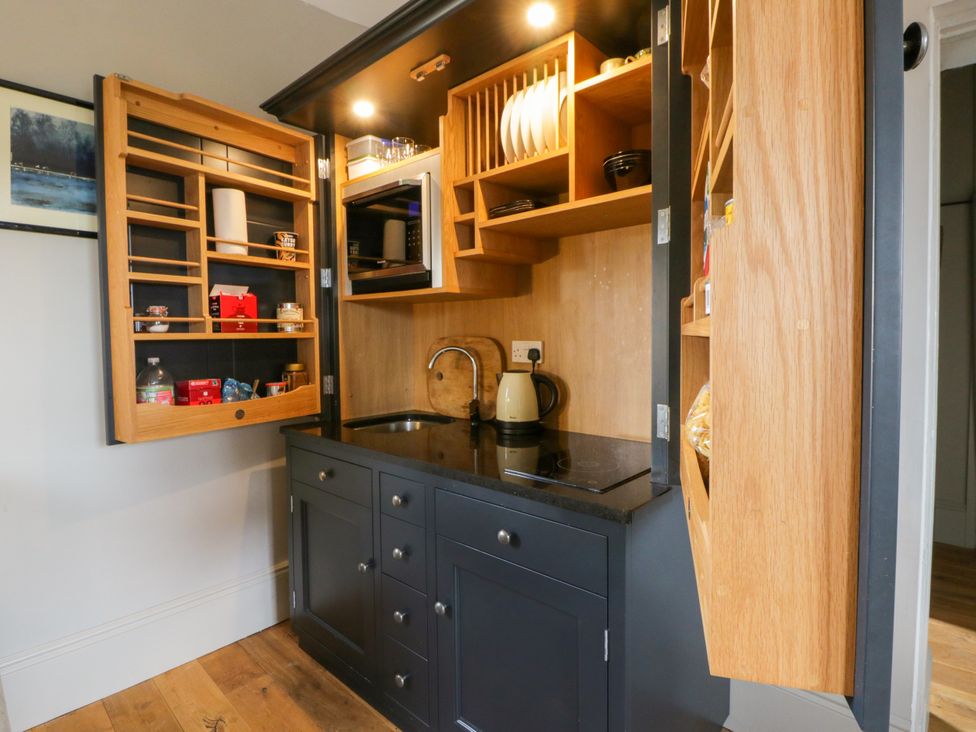 A kitchen with storage units and a sink at Flat 5 in Hereford