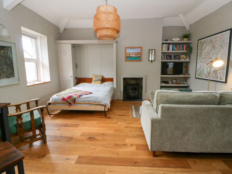 A living room with a bed and sofa at Flat 5 in Hereford