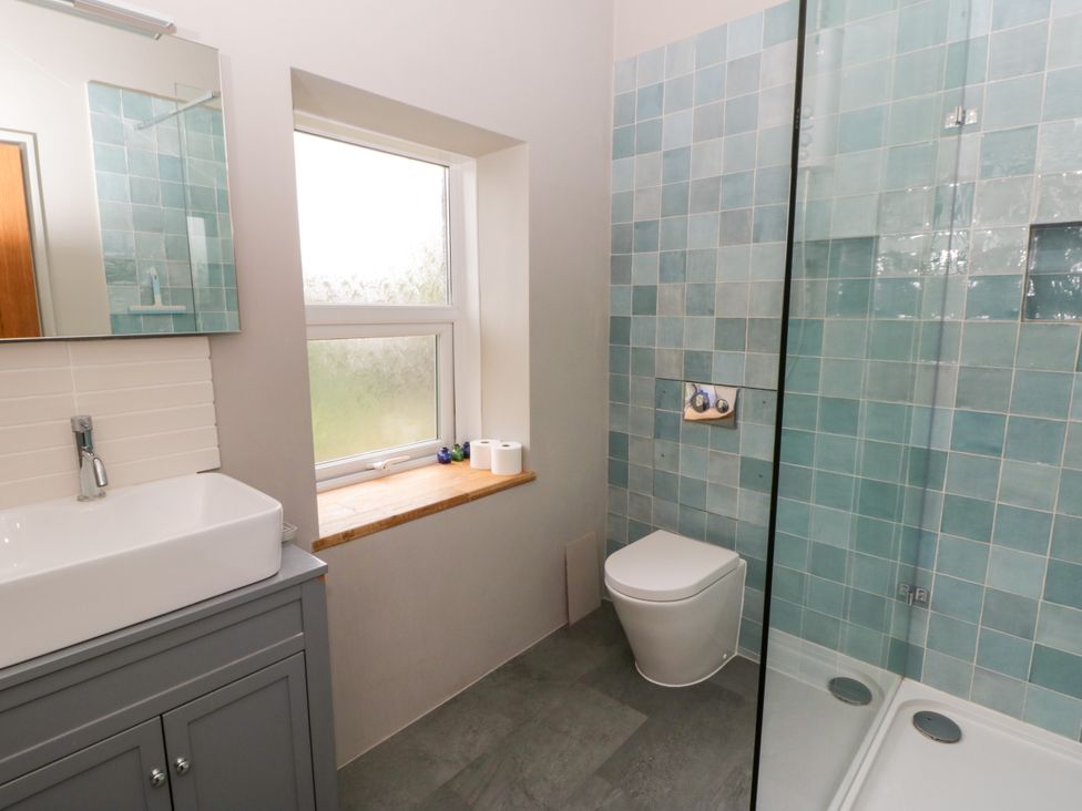 A bathroom with a sink, toilet, and shower at Flat 5 Hereford
