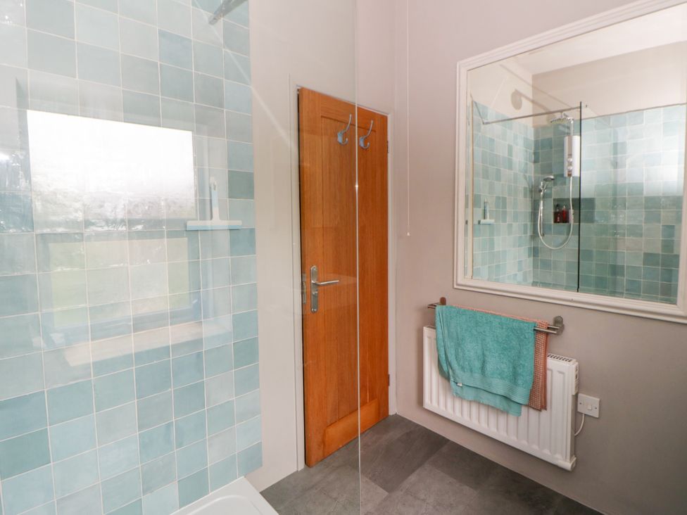 A bathroom with a shower and towel rack at Flat 5 Hereford