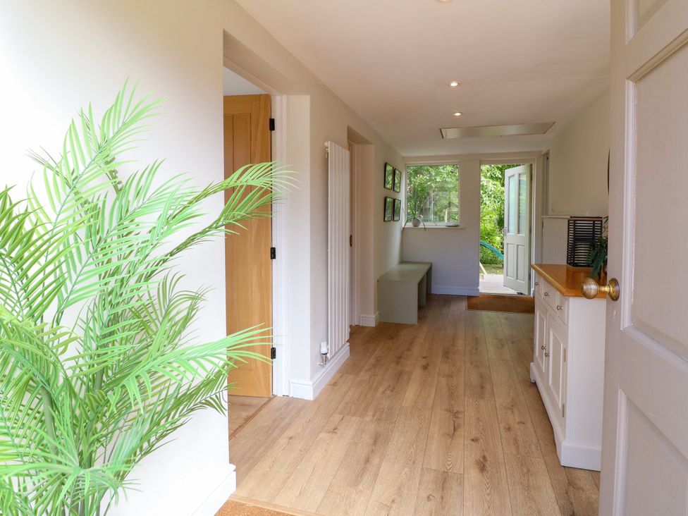 A hallway with a bench and plant at 7 Forge Close 