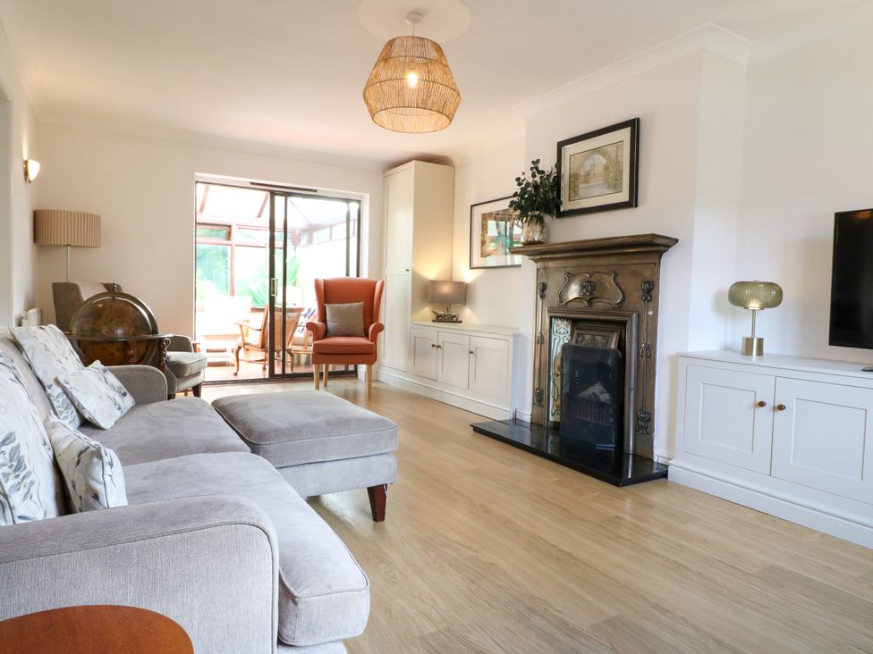 A living room with a sofa and fireplace at 7 Forge Close 