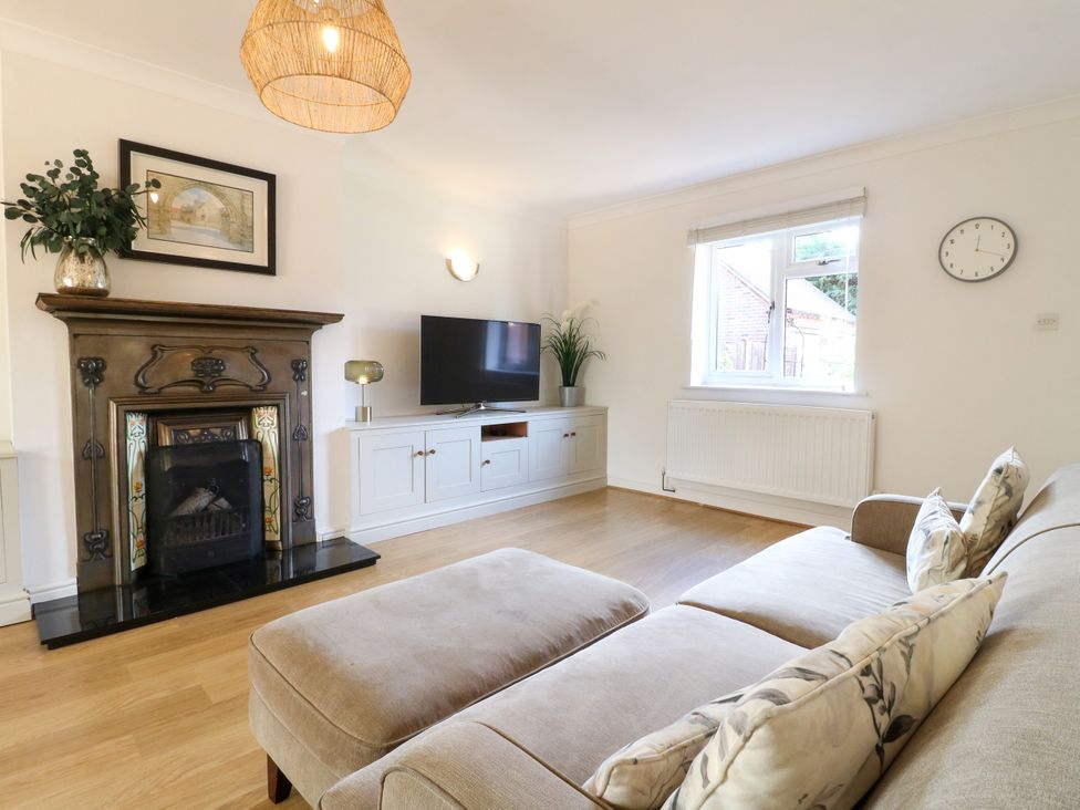 A living room with a sofa and television at 7 Forge Close