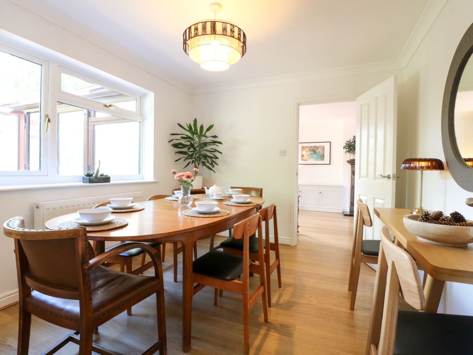 A dining room with a table set for a meal at 7 Forge Close