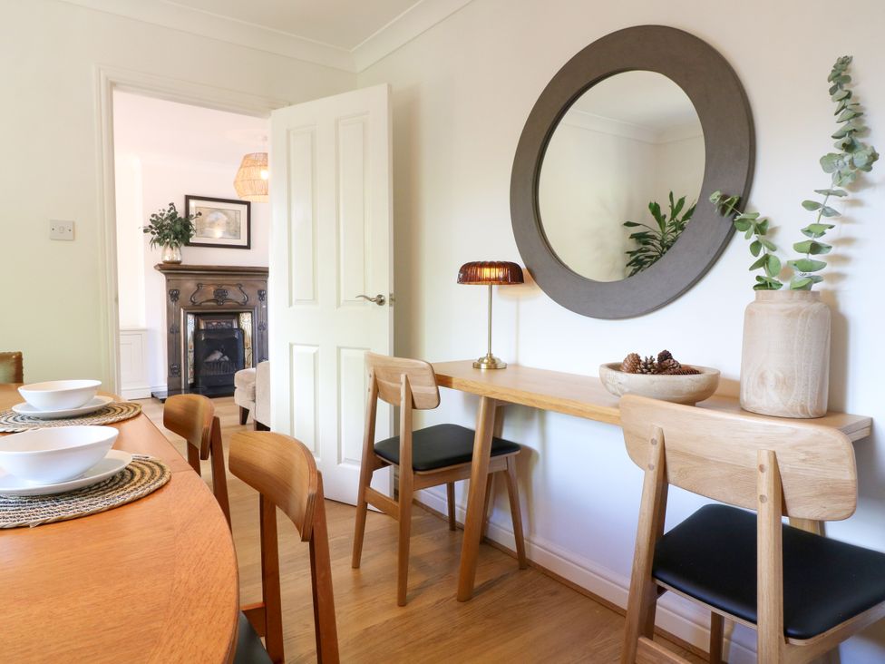 A dining room with a table and chairs at 7 Forge Close
