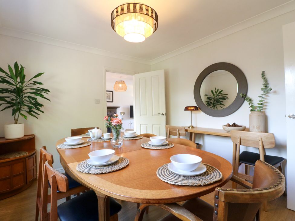 A dining room with a wooden table and chairs at 7 Forge Close