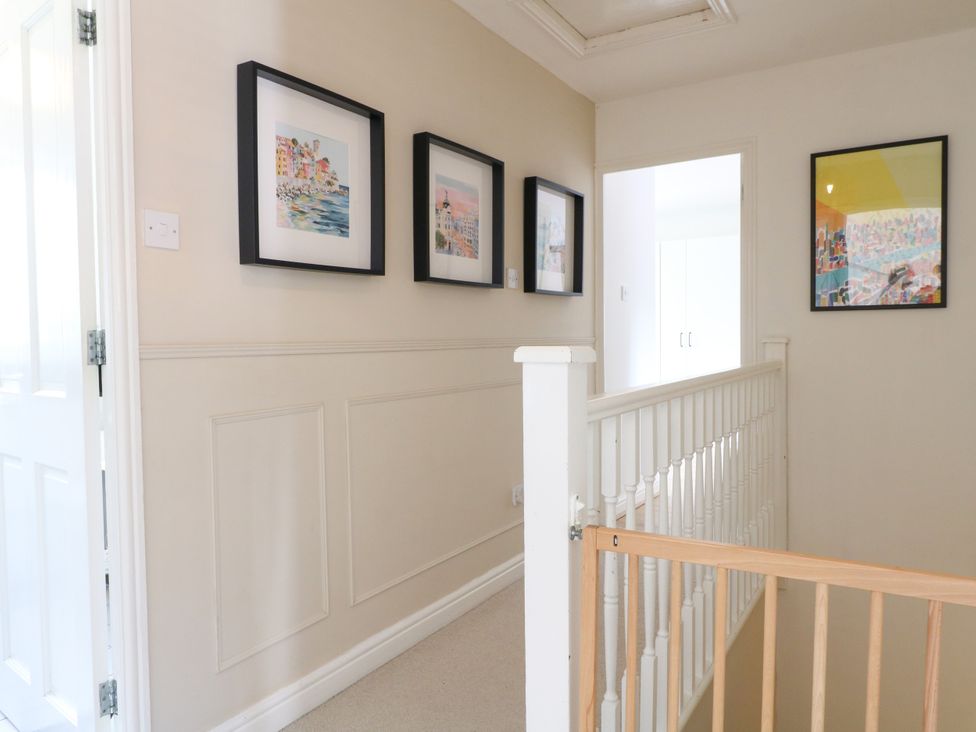A hallway with artwork on the wall at 7 Forge Close 