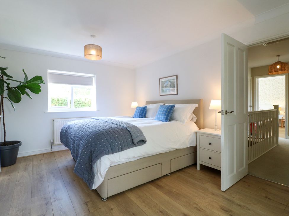 A bedroom with a bed and a plant at 7 Forge Close