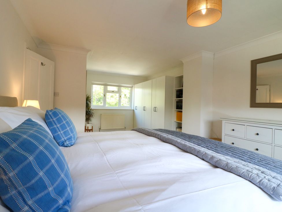 A bedroom with a bed and wardrobe at 7 Forge Close