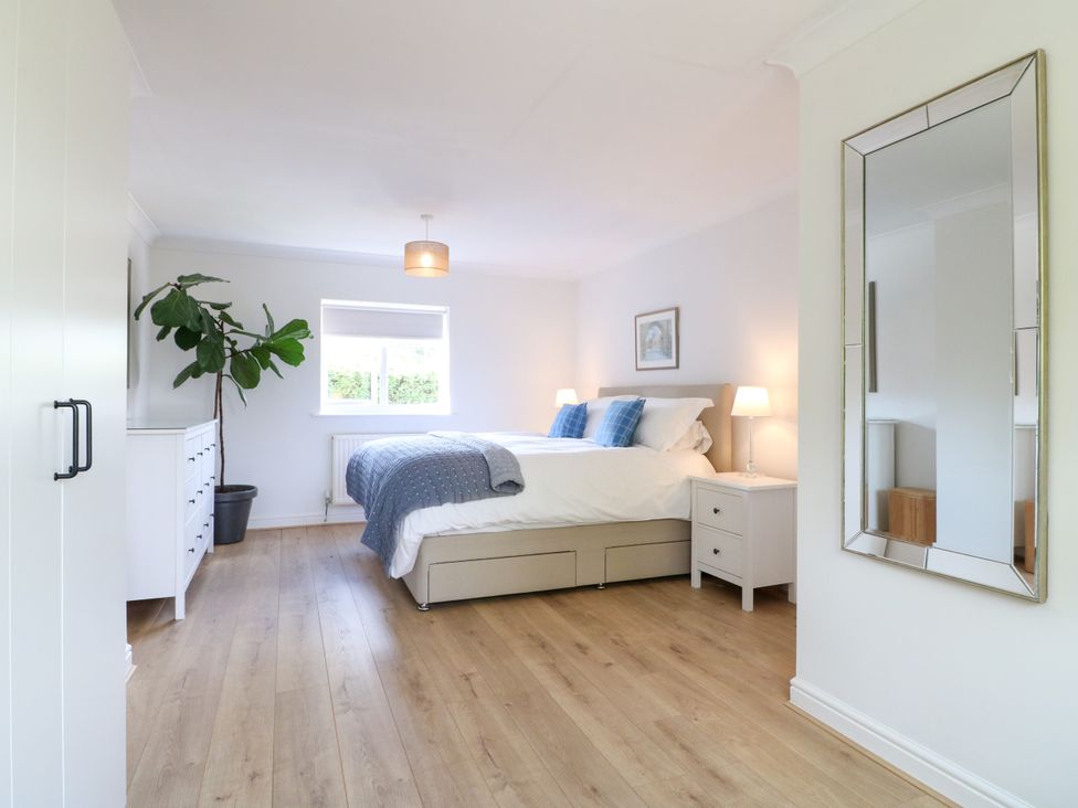 A bedroom with a bed and plant at 7 Forge Close