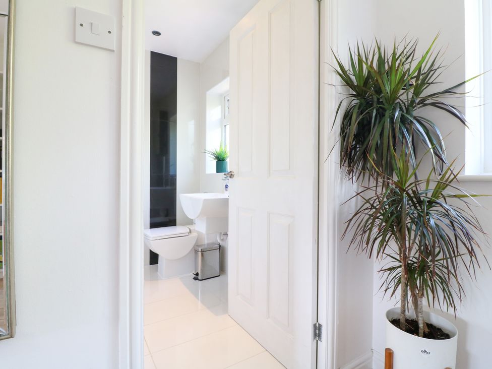 A bathroom with a toilet and sink at 7 Forge Close
