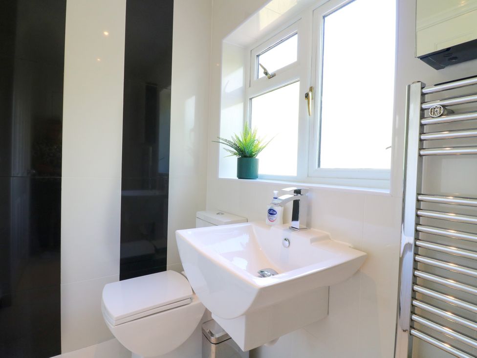 A bathroom with a toilet and sink at 7 Forge Close
