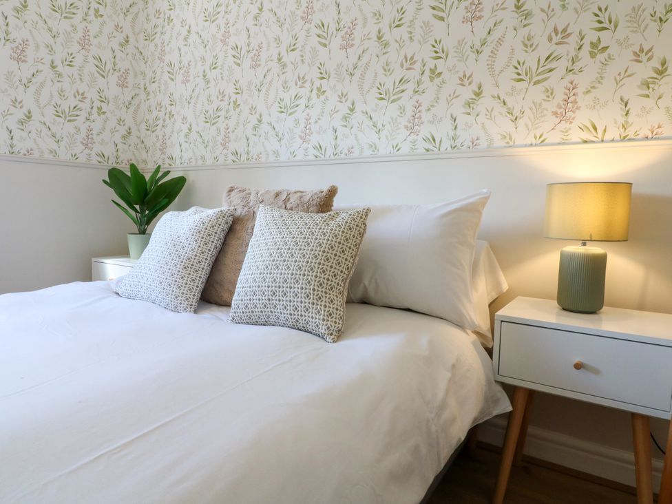 A bedroom with a bed and pillows at 7 Forge Close