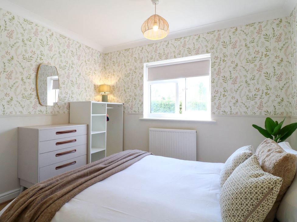 A bedroom with a bed, dresser and a window at 7 Forge Close