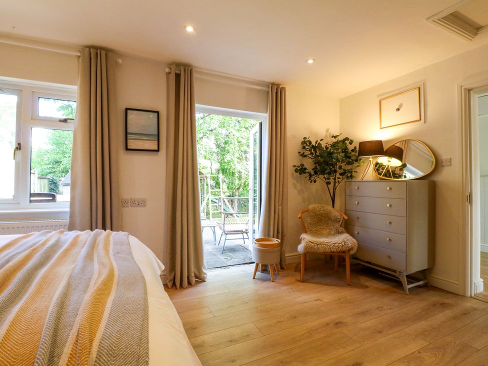 A bedroom with a bed and dresser near a window at 7 Forge Close