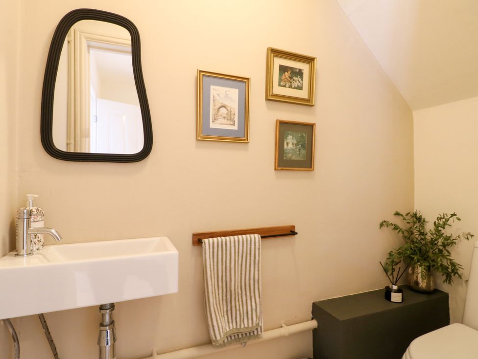 A bathroom with a sink and wall art at 7 Forge Close