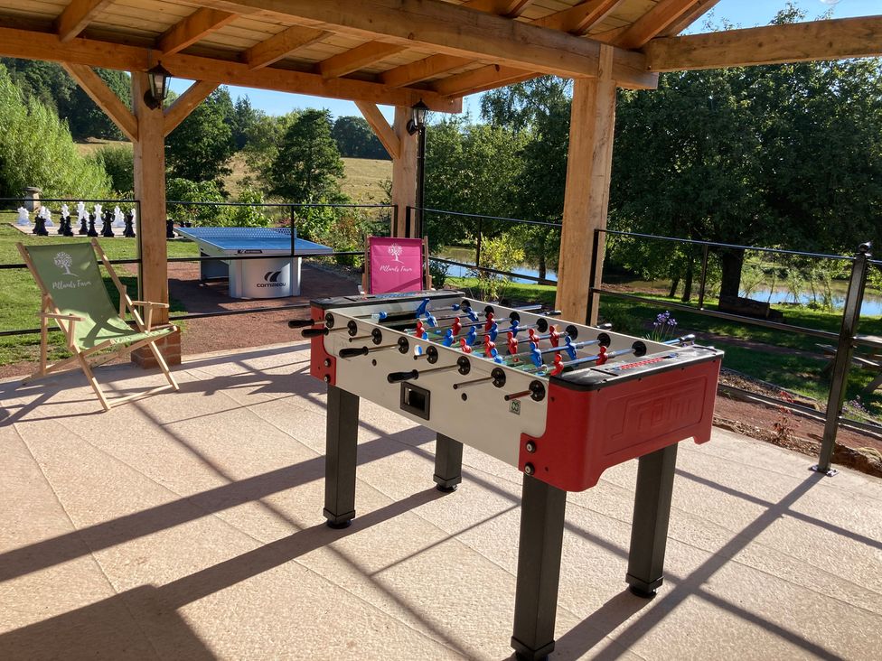 An outdoor area with a foosball table and ping pong table at Chestnut Lodge in Worcester