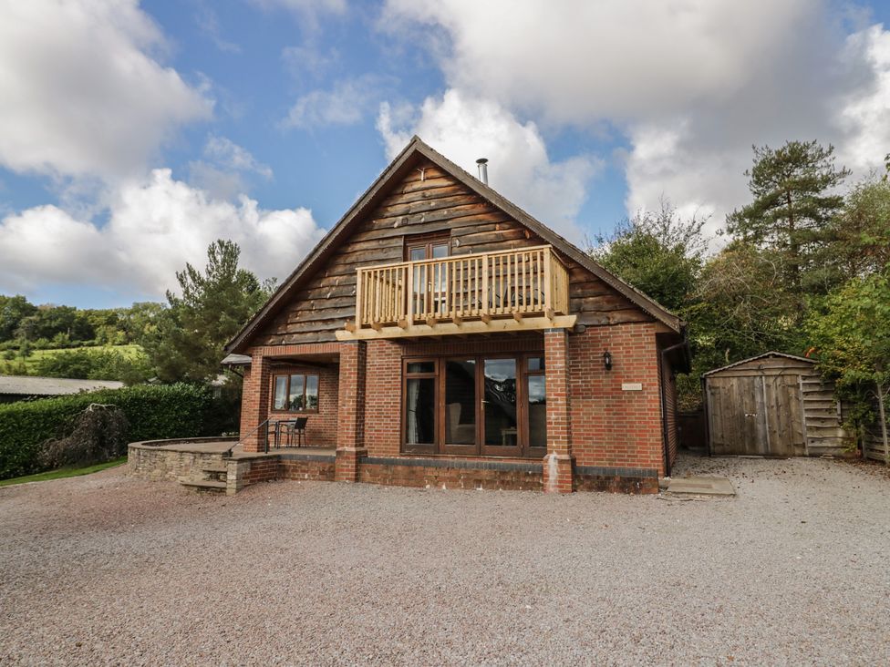 A house with a balcony and gravel driveway at Chestnut Lodge in Worcester