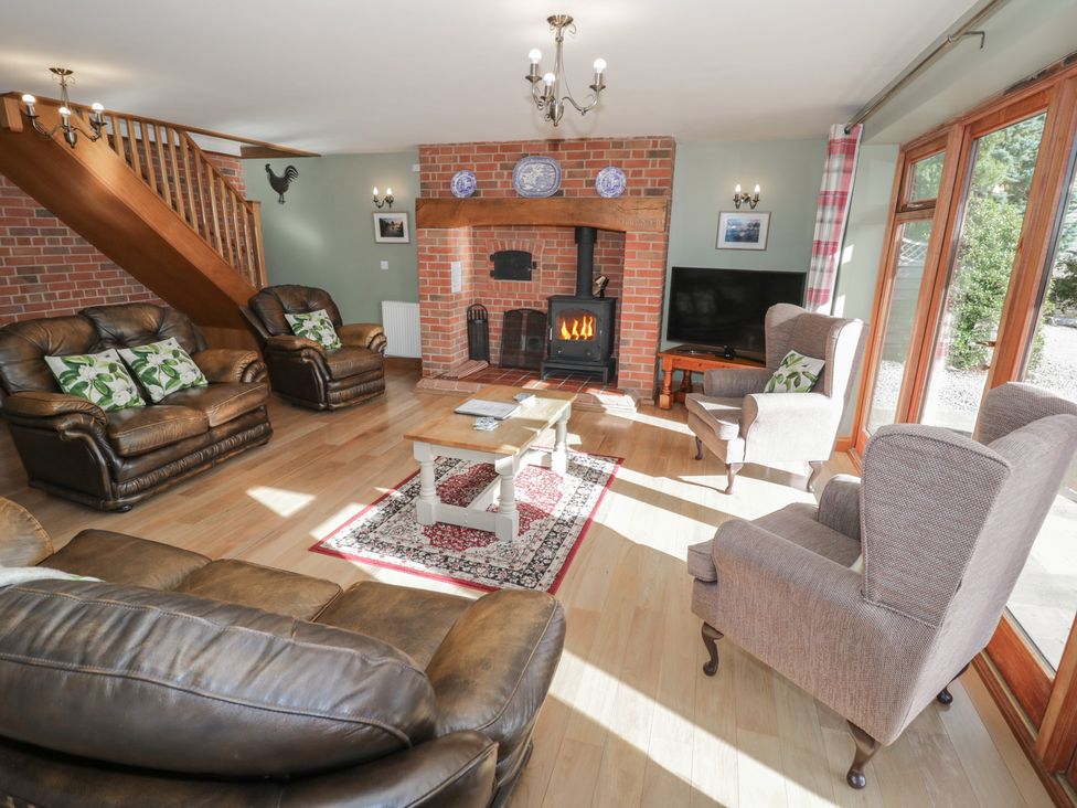 A living room with sofas and a fireplace at Chestnut Lodge in Worcester