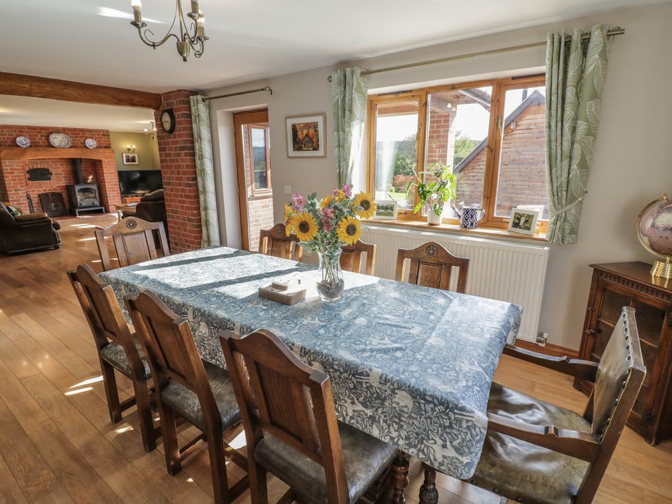 A dining room with a large table and chairs at Chestnut Lodge Worcester
