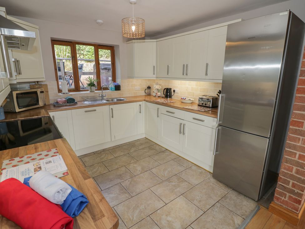A kitchen with appliances and wooden countertops at Chestnut Lodge in Worcester