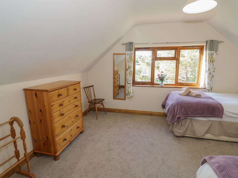 A bedroom with a bed and dresser at Chestnut Lodge Worcester