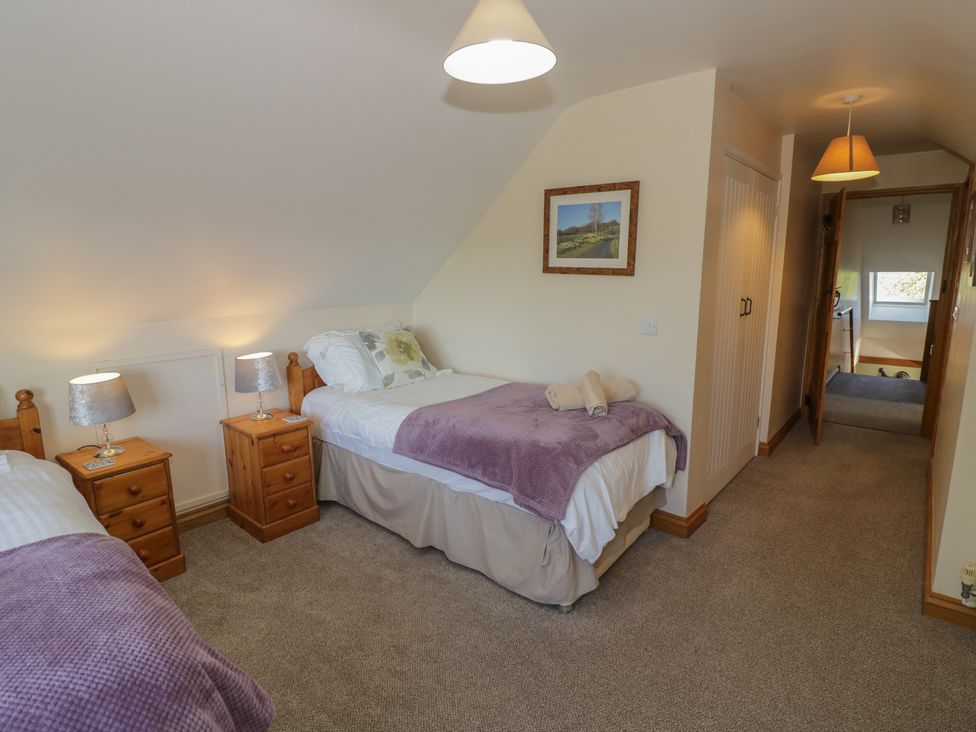 A bedroom with two beds and a picture at Chestnut Lodge in Worcester