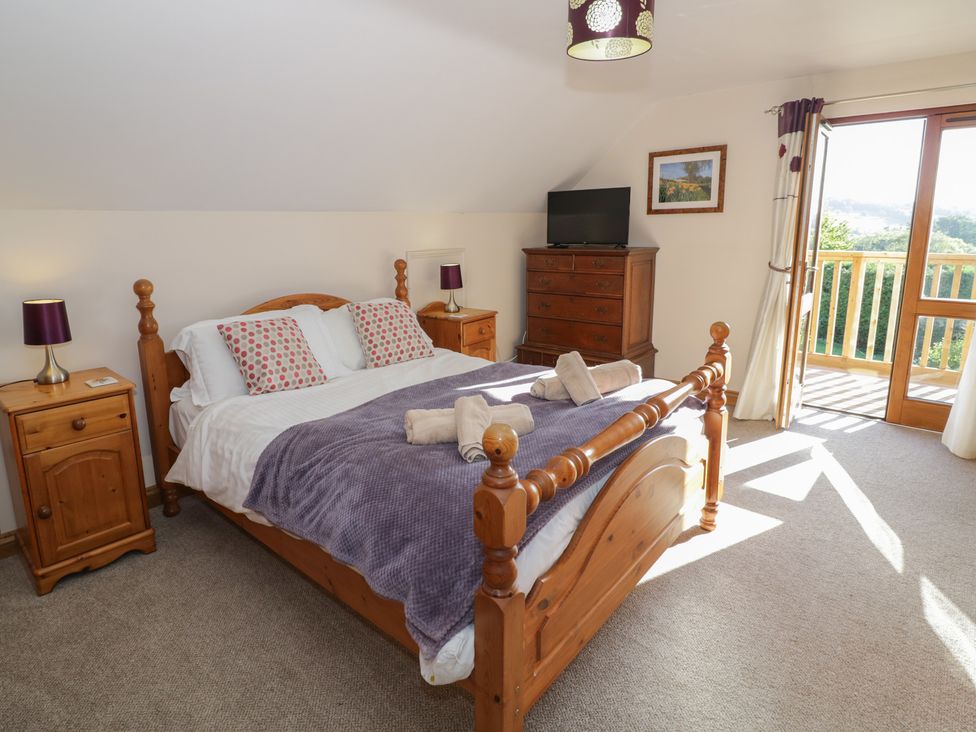 A bedroom with a bed and a dresser at Chestnut Lodge in Worcester