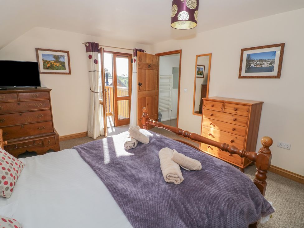 A bedroom with a bed and dresser at Chestnut Lodge in Worcester