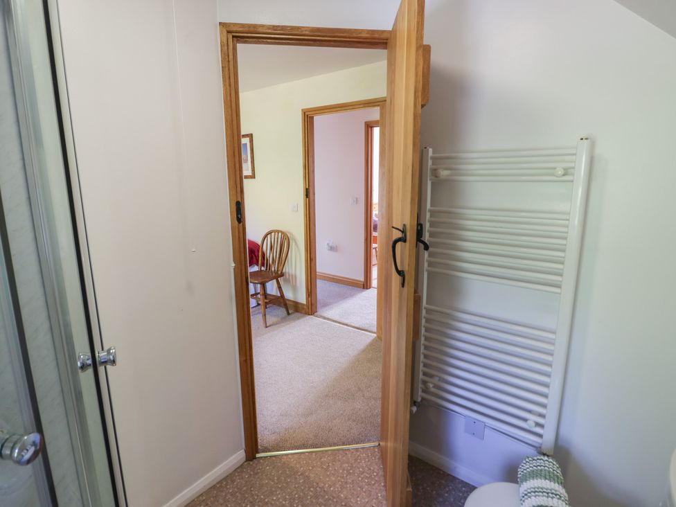 A bathroom with a towel rail and a doorway to another room at Chestnut Lodge Worcester