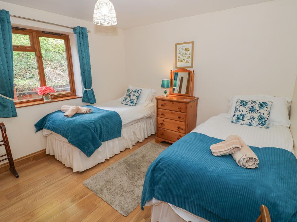 A bedroom with two beds and a dresser at Chestnut Lodge in Worcester