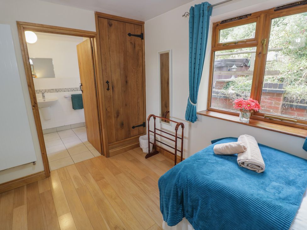 A bedroom with a bed and wardrobe at Chestnut Lodge in Worcester